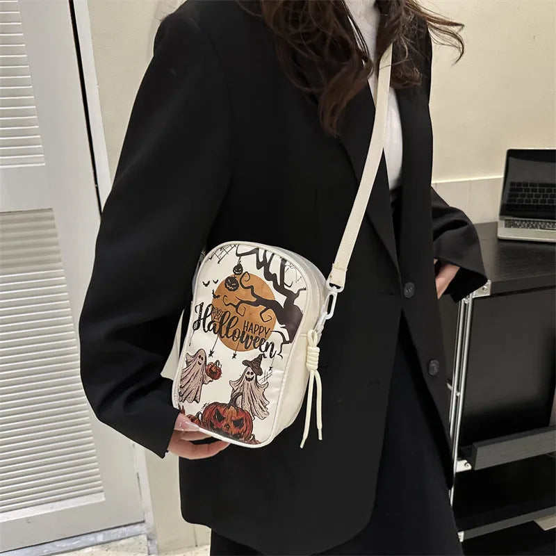 Halloween-themed crossbody phone bag with cartoon pumpkin, ghost, and bat print.
