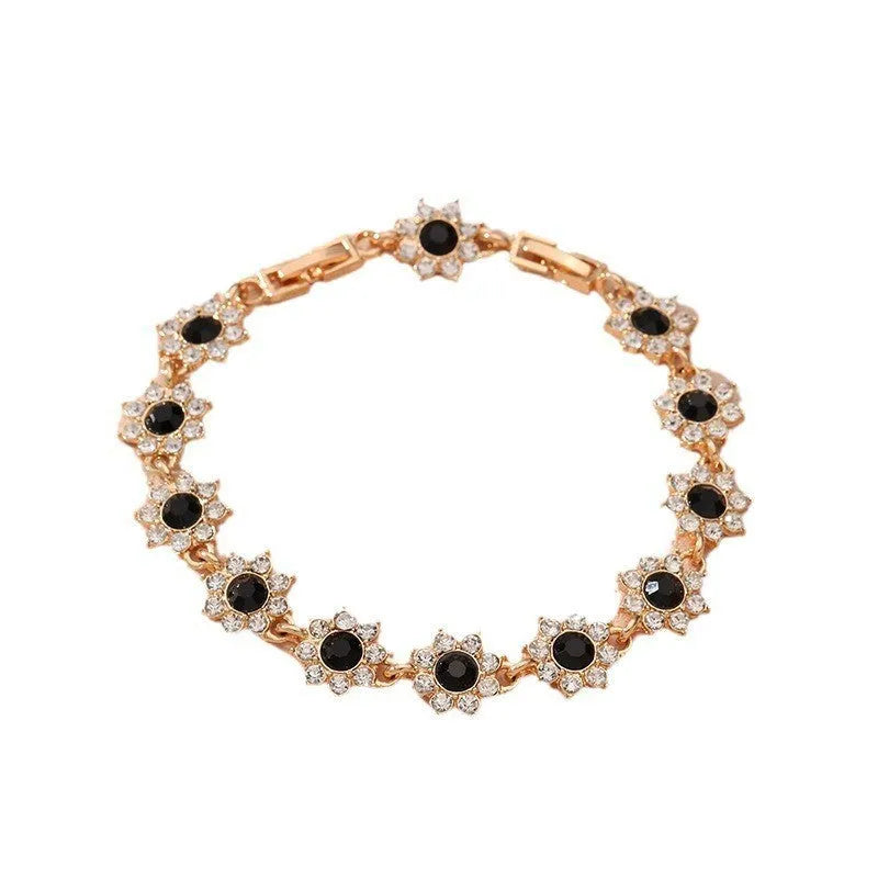 Electroplated zinc alloy bracelet with flower-shaped design and coloured gem elements in metallic finish