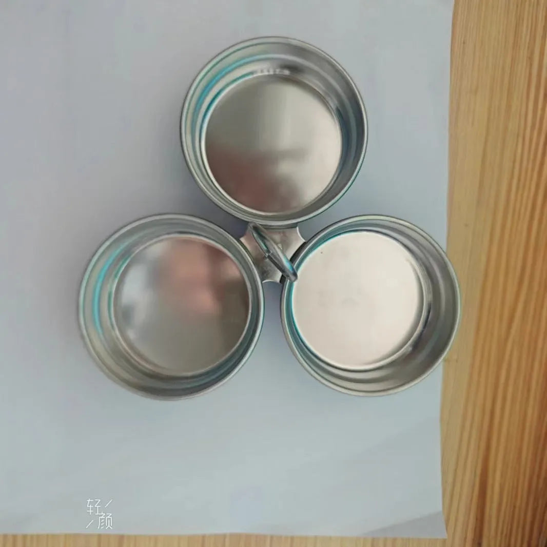 Mini stainless steel heart-shaped egg steamer for cooking soft-boiled or poached eggs on a stove.