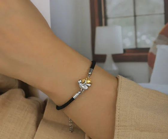 Woven black flexible wire couple bracelet with angel element and electroplated finish