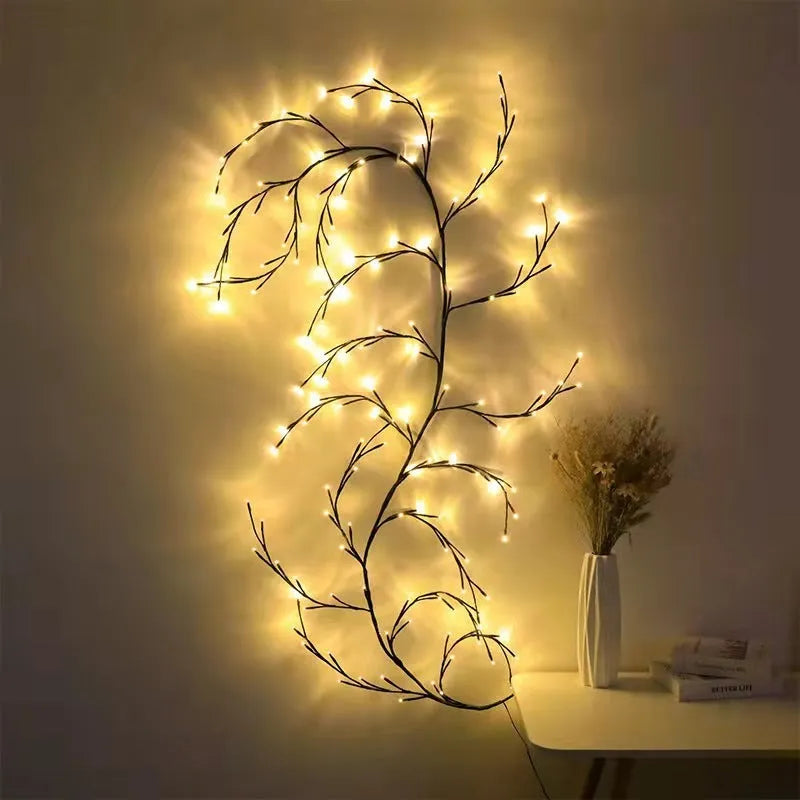 Flexible white birch LED vine light garland bent into decorative shape with warm white lights