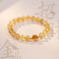 Gold rutilated quartz crystal bracelet with diamond-shaped links and natural citrine beads