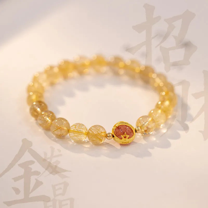 Gold rutilated quartz crystal bracelet with diamond-shaped links and natural citrine beads