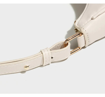 Women's soft PU crescent crossbody bag with internal compartments in white and black