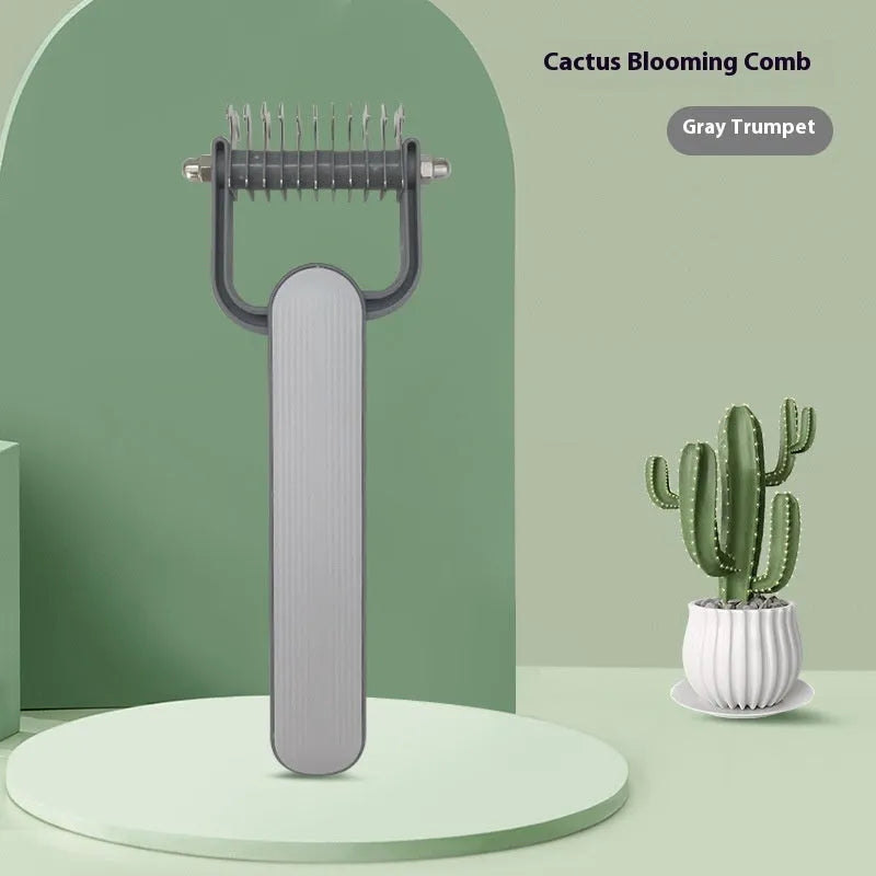 Green and grey dog detangling comb with stainless steel teeth on a polypropylene handle.