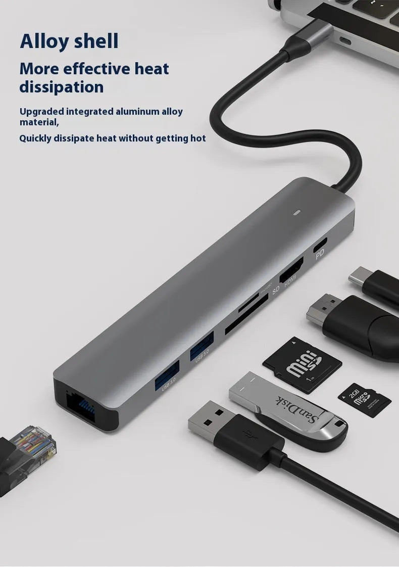 Silver aluminium 7-in-1 USB-C hub with SD card slot, microSD slot, USB-A, and USB-C ports.