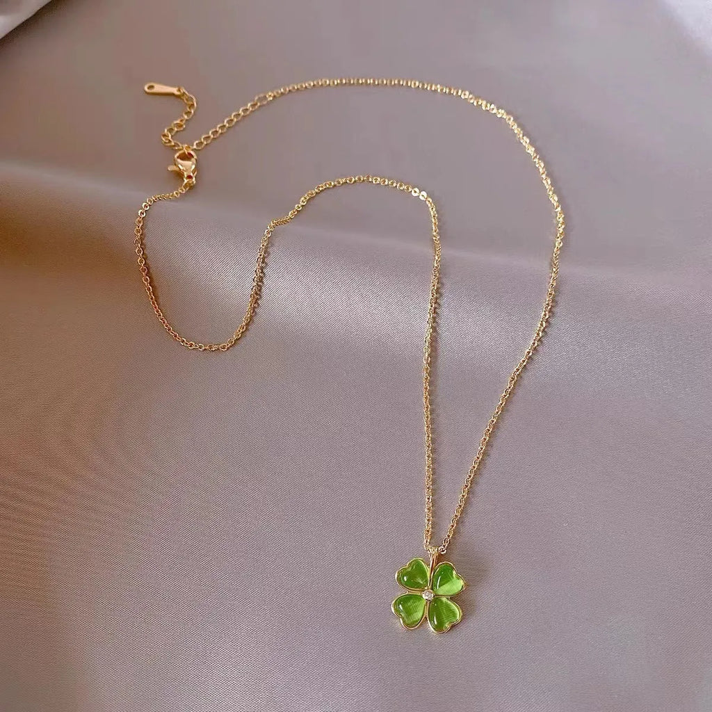 Titanium steel golden clavicle chain with geometric four-leaf flower design on unisex display