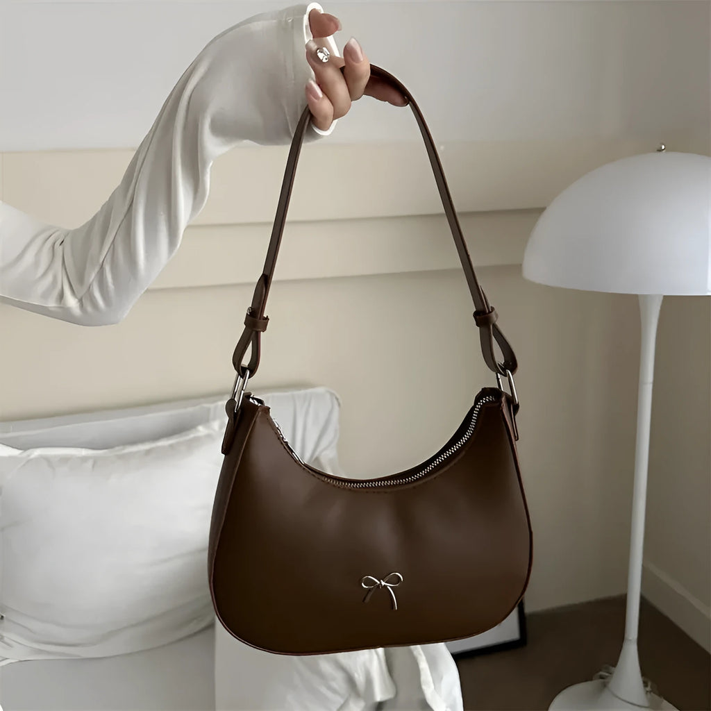 Women's dumpling-shaped shoulder baguette handbag in PU material with single strap and mobile phone compartment