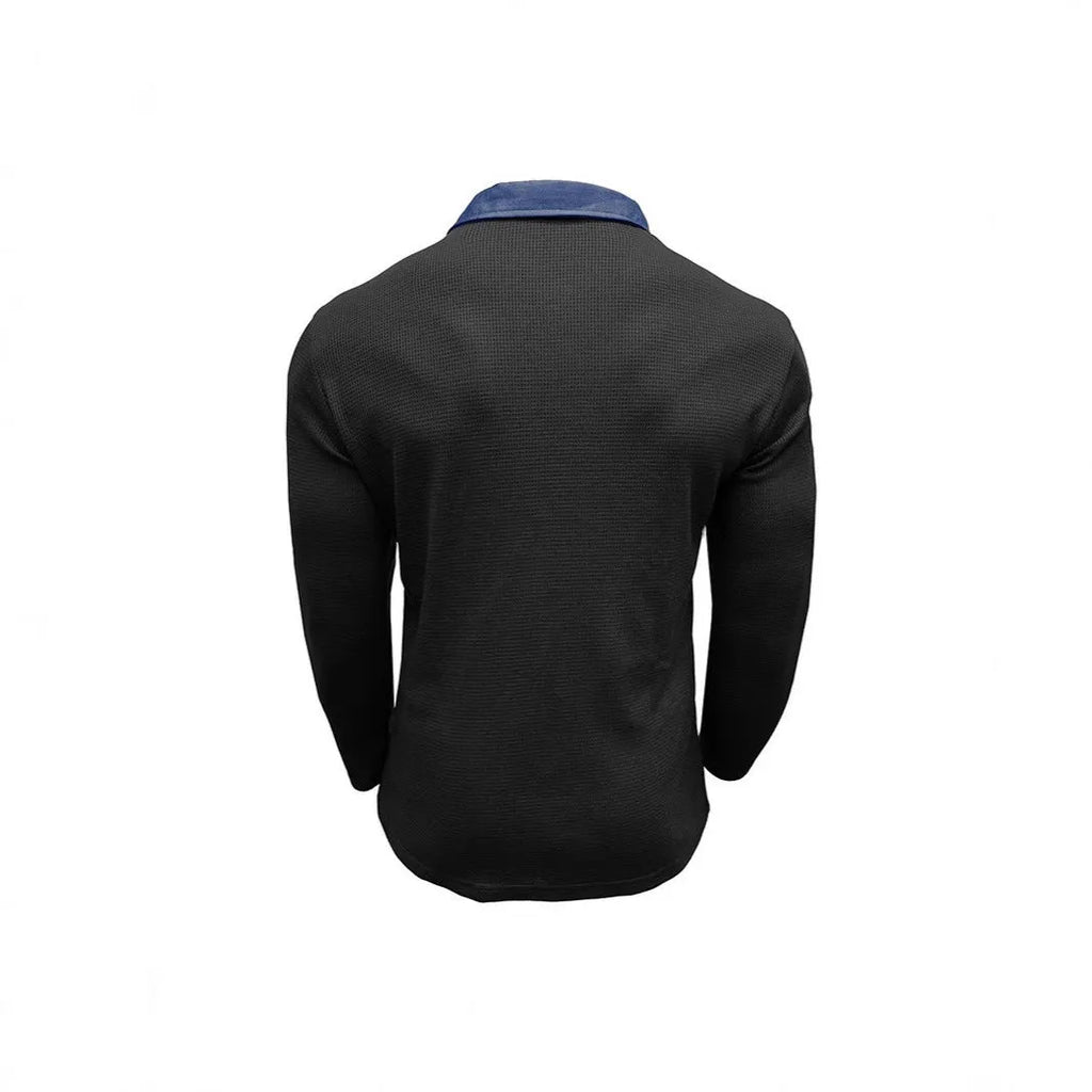 Man wearing a loose-fit long-sleeved waffle-texture polo shirt in a dark colour.