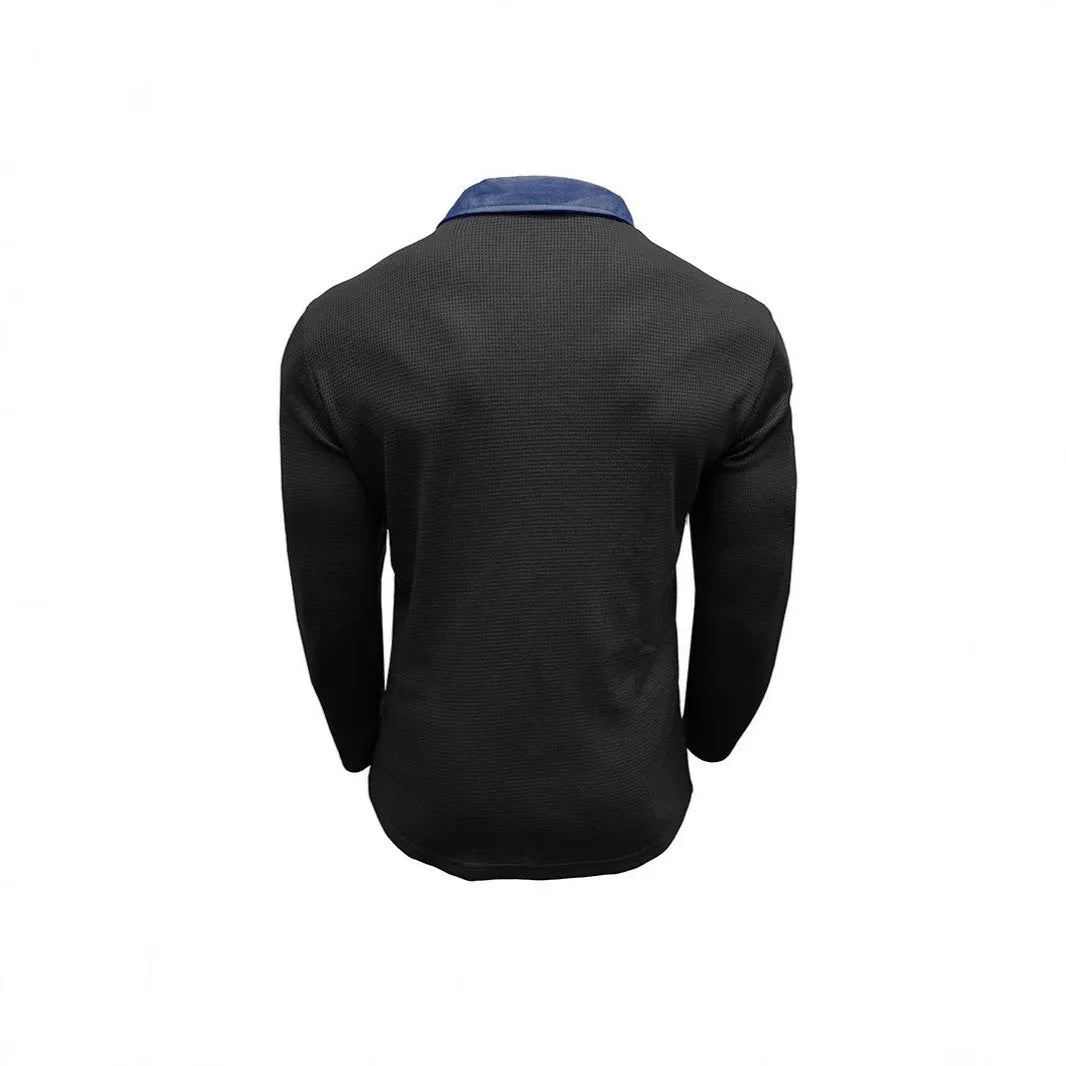 Man wearing a loose-fit long-sleeved waffle-texture polo shirt in a dark colour.