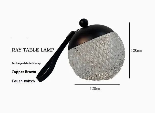 Small cylindrical portable night lamp with touch dimmer in chrome, gold, black, coppery brown, or white finish.