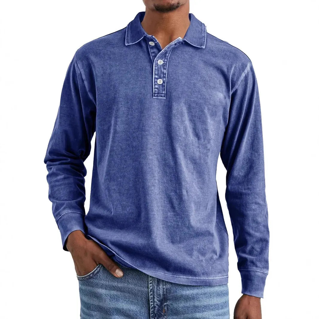 Man wearing a retro washed grey cotton polo shirt with distressed details and a lapel collar.