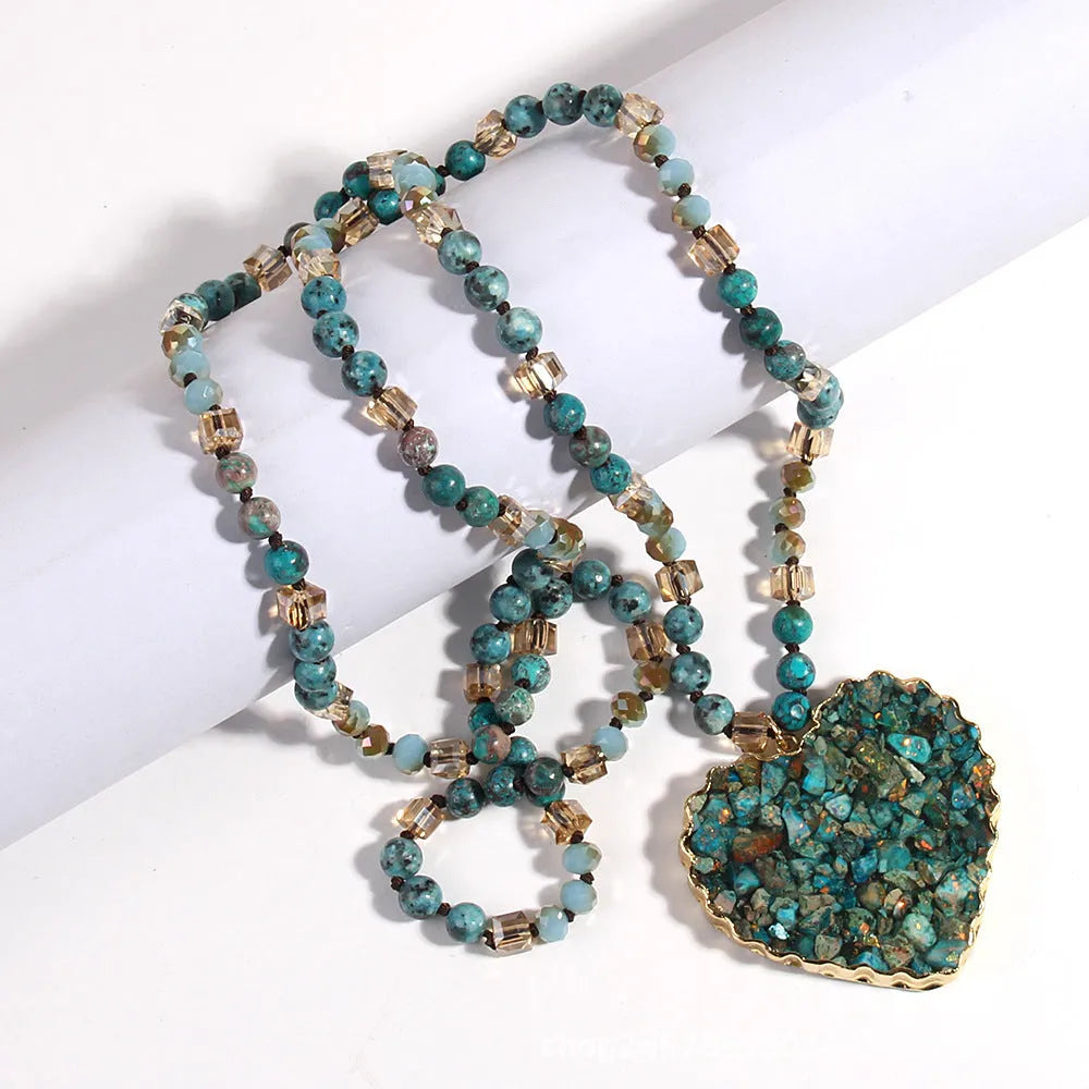 Bohemian style long chain heart pendant necklace in stone and glass with electroplated finish, available in multiple colours.