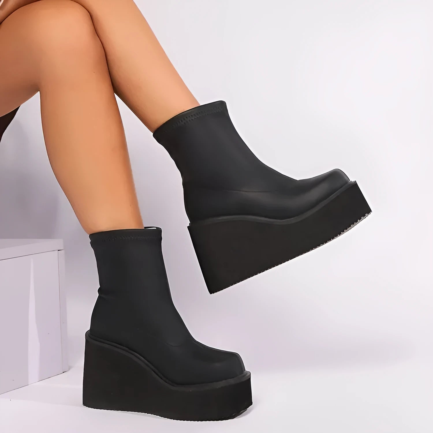 Plus size women's black wedge heel ankle boots with a waterproof platform and round toe.