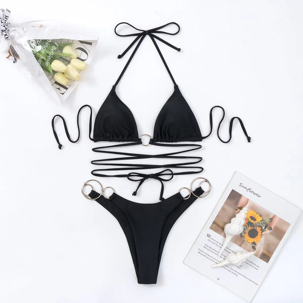 Black women's bikini set with metal ring detail on the long straps and a split bottom style.