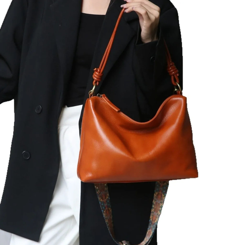 Genuine leather creative large capacity hand shoulder commuter bag in black, pillow shape, 31x11x24cm