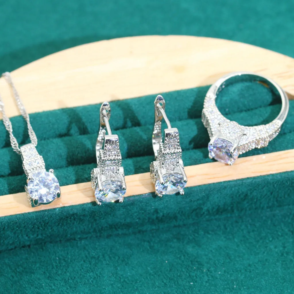 Bridal zircon four-piece jewellery set showing necklace, bracelet, earrings and ring with water wave chain design