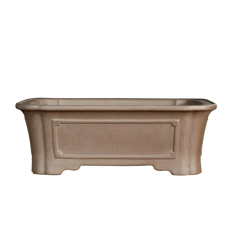 Antique-style rectangular purple sand bonsai pot on a floor.