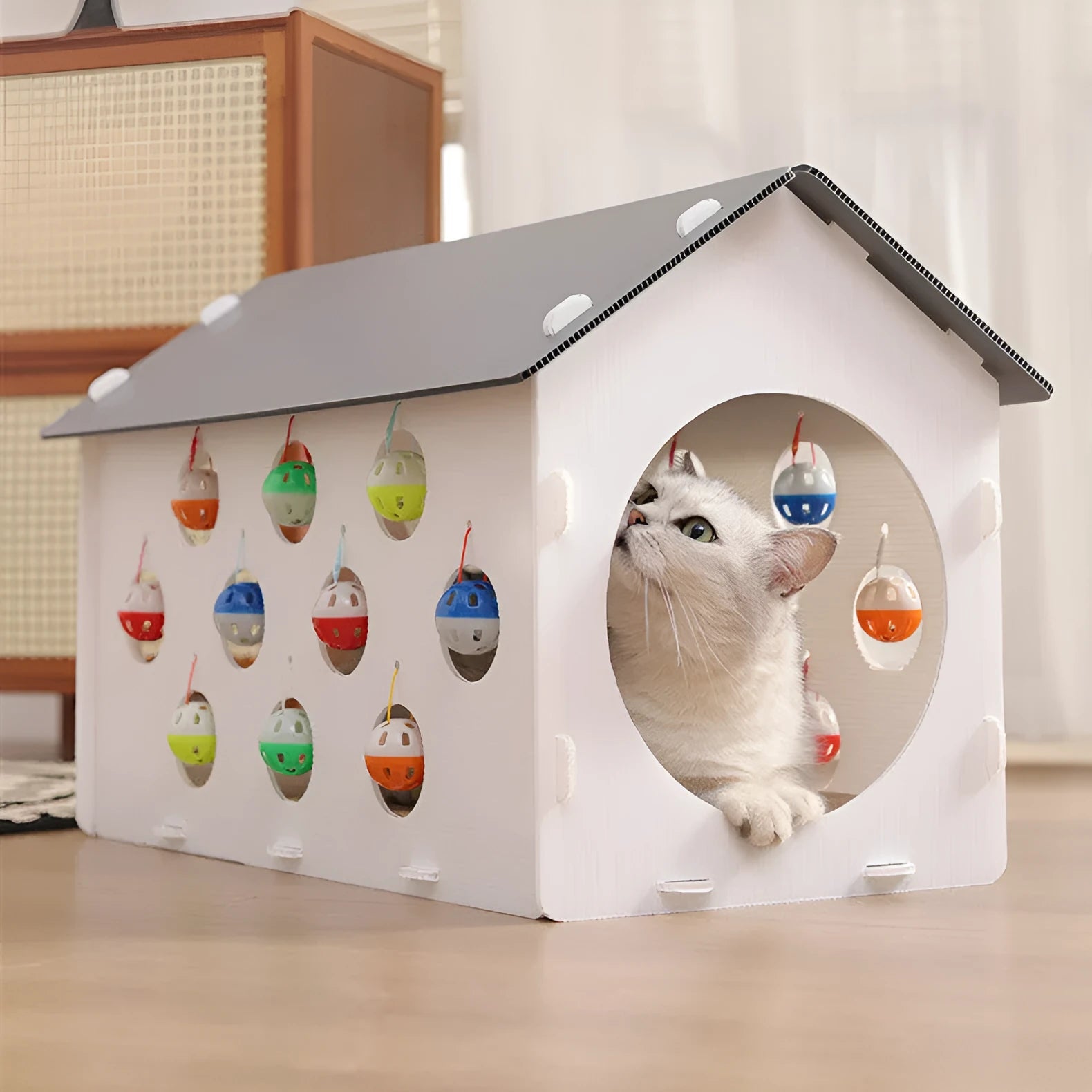 Plastic cat scratch board integrated with a nest, a bell ball, and a tunnel for pet play and rest.