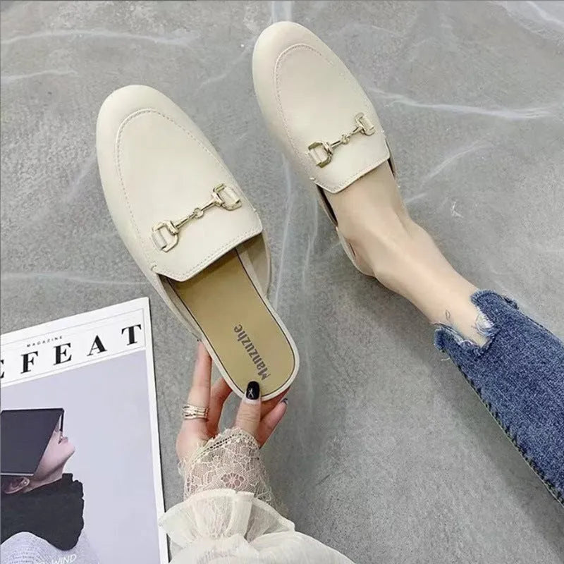 Women's PVC closed toe half slippers shown in milky white colour with a double buckle fastener.