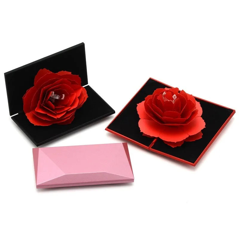 Red 3D heart-shaped rotating ring box with a rose flower decoration, open to show ring placement.
