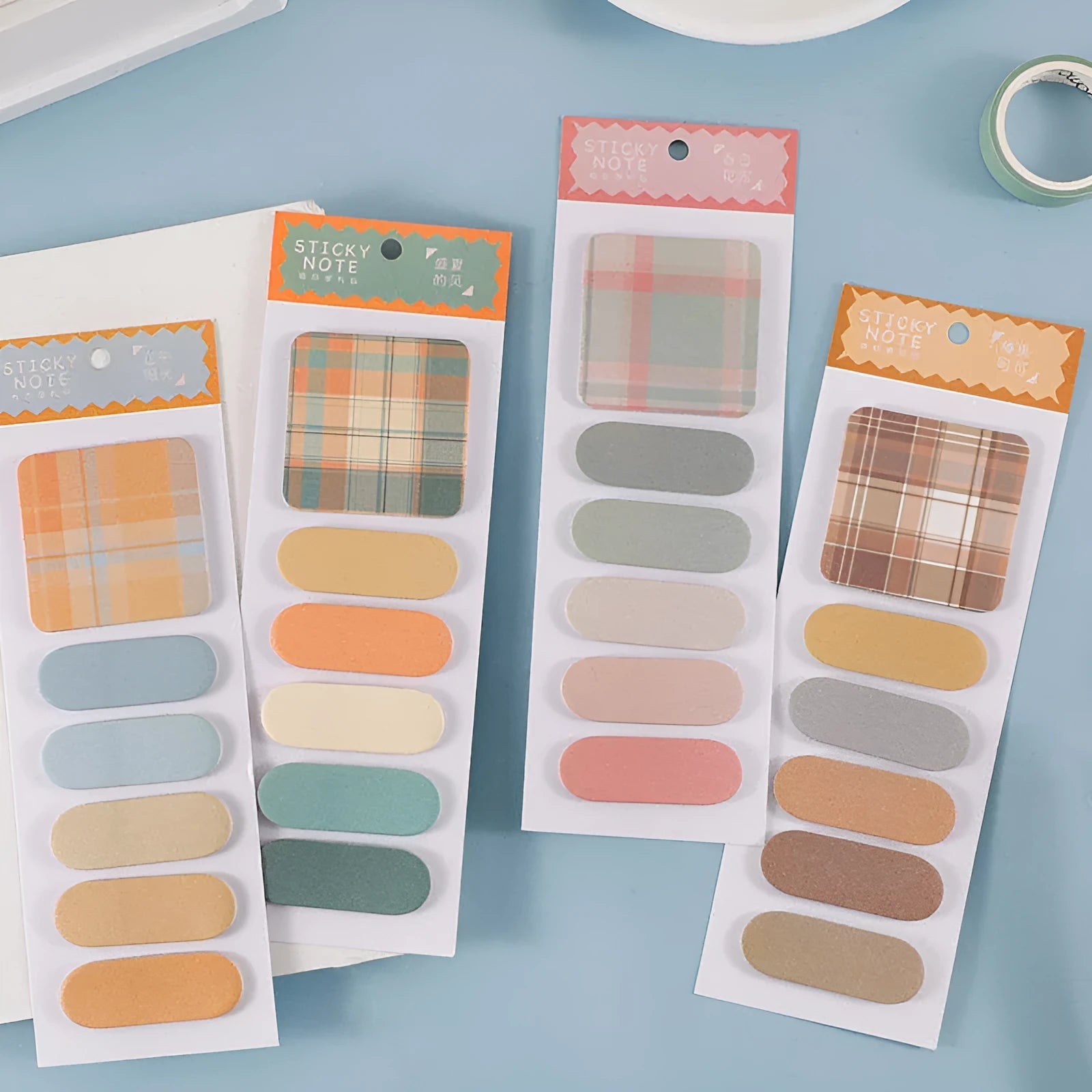 Set of eight colourful plaid and solid-colour memo pads, each with sticky notes measuring 67mm by 200mm.