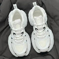 Beige mesh platform sports shoes with a wedge heel and front lace-up fastening on a rubber sole.