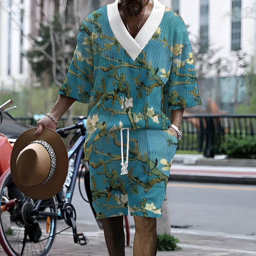 Man wearing a peacock blue 3D printed knit shorts suit with a T-shirt jacket.