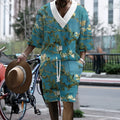 Man wearing a peacock blue 3D printed knit shorts suit with a T-shirt jacket.