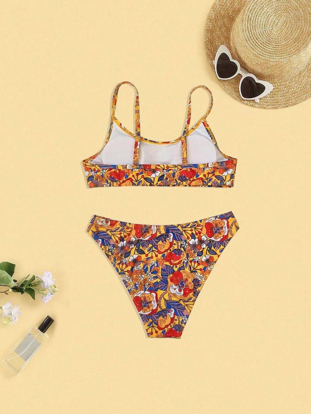 Plus size women's floral print bikini swimsuit with strap design on white background