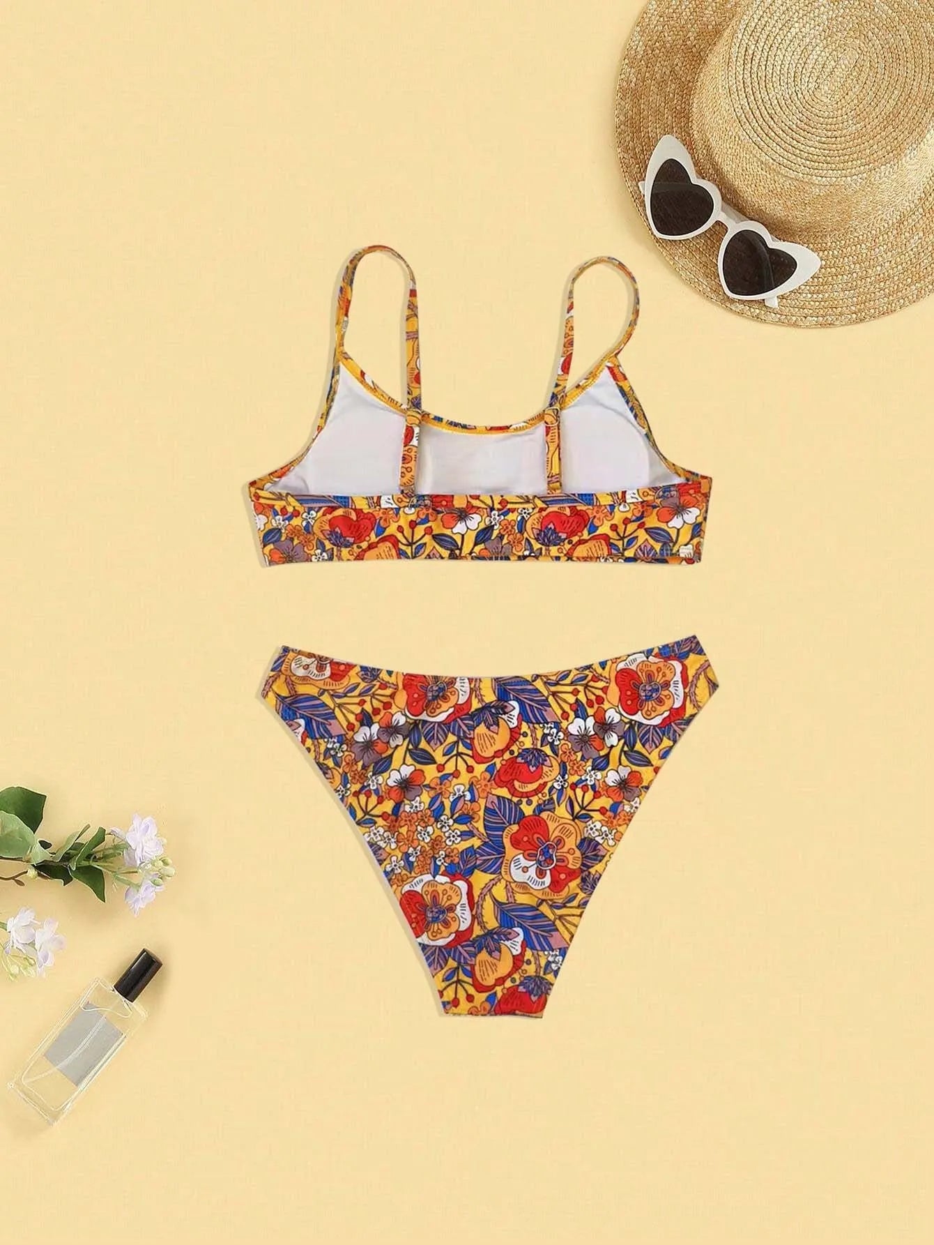 Plus size women's floral print bikini swimsuit with strap design on white background