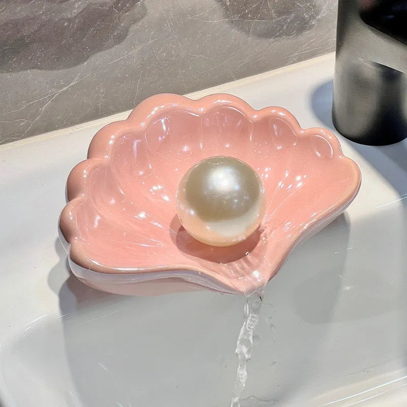 Shell-shaped plastic soap dish in pearl white or cherry blossom pink for bathroom use