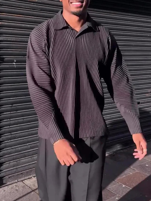 Men's black long-sleeved casual top with a pleated design detail.