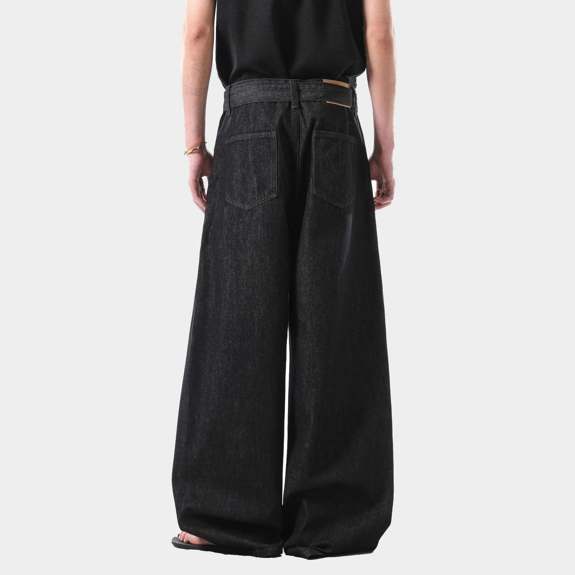 Black women's high-waist straight-leg jeans with gold stitching and a zip fly closure.