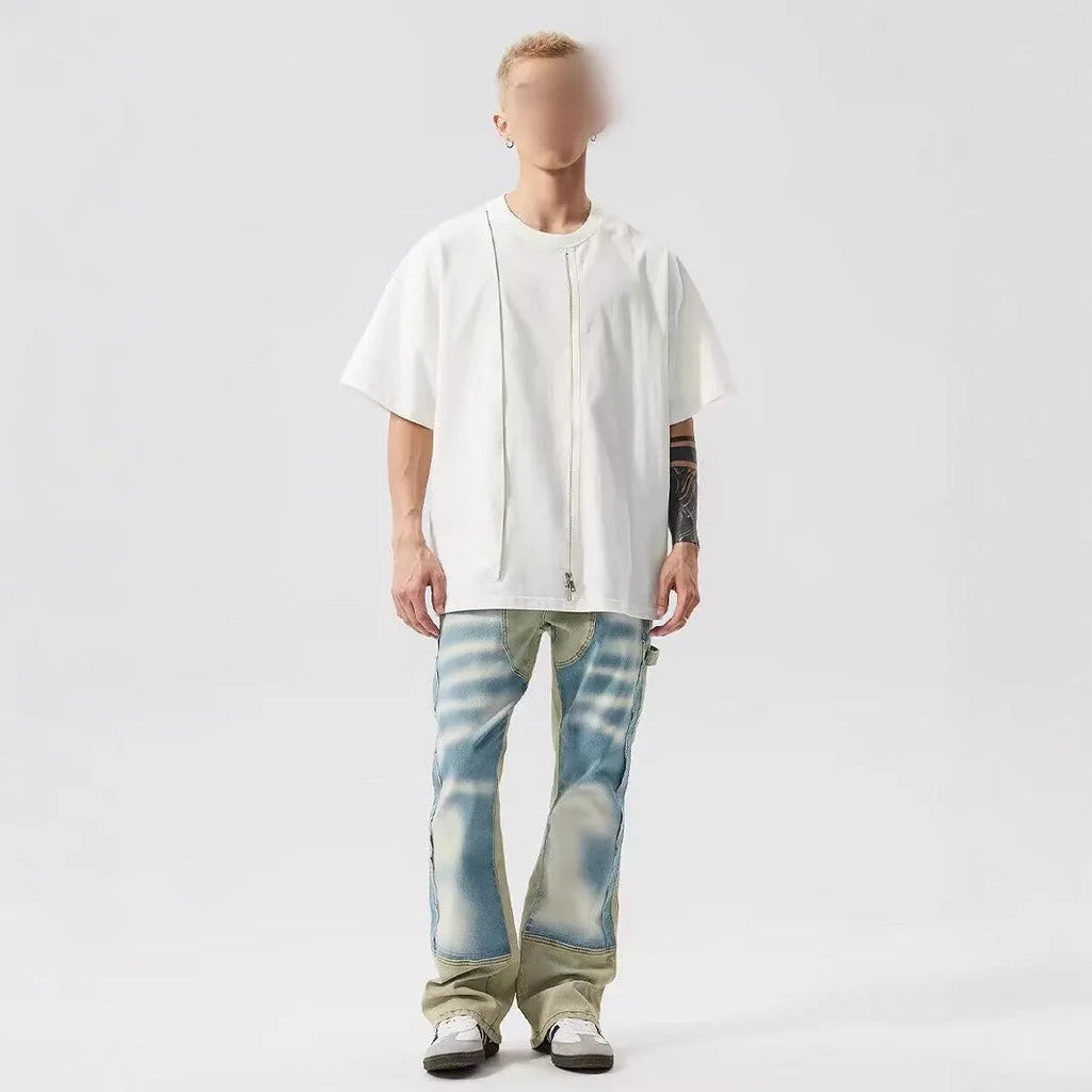 Yellow and blue retro patchwork jeans with splash-ink distressed design on a mid-waist trouser cut.