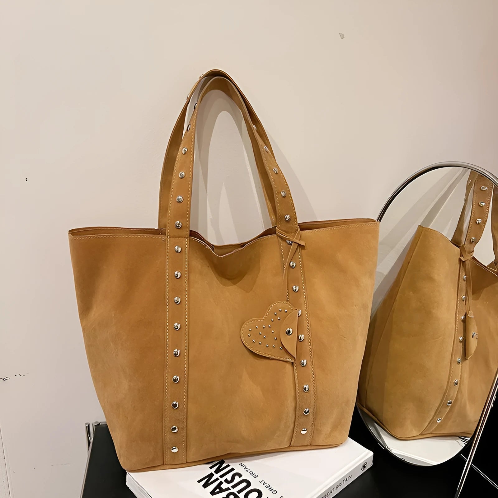 Black PU leather tote bag with double shoulder straps, showing interior sandwich pocket organiser.