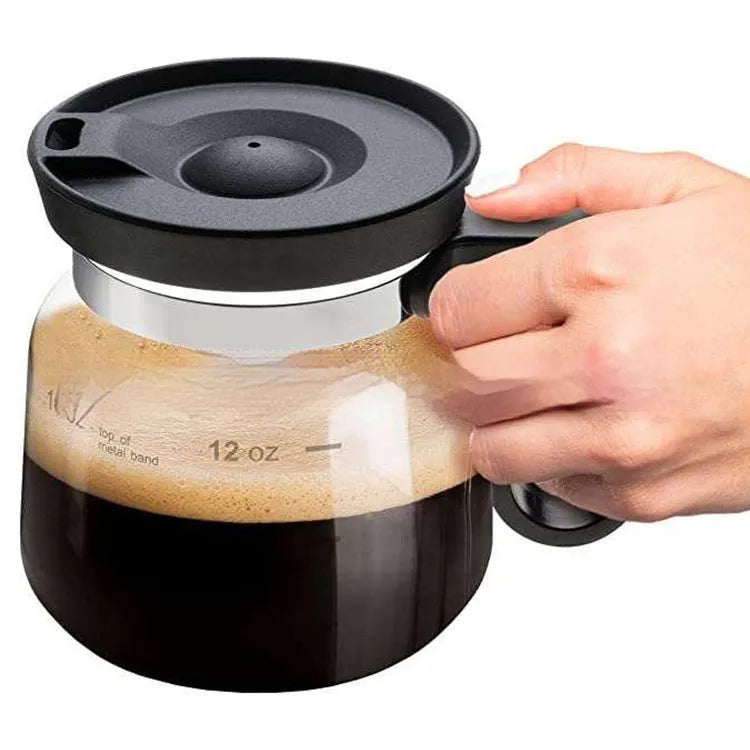 Transparent borosilicate glass coffee maker with a black silicone cover for pour-over brewing.