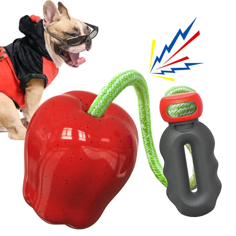 Green and red plastic apple-shaped dog chew toys for molar cleaning and outdoor play.