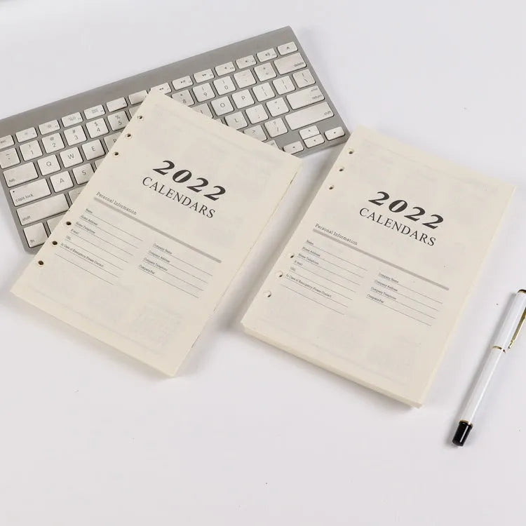 White A5 loose-leaf notebook inner pages with monthly plan layout on paper
