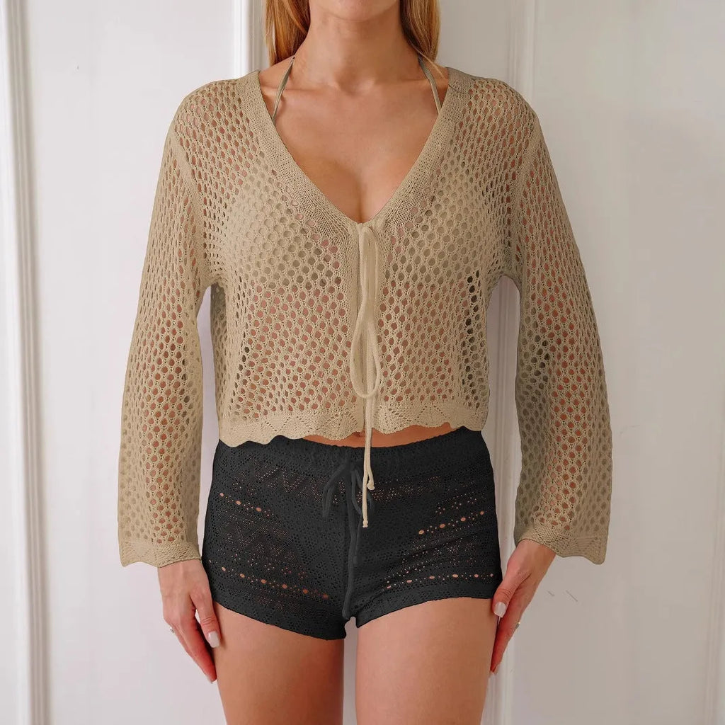 Short apricot-coloured women's cardigan blouse with bell sleeves, showing hollow woven texture.