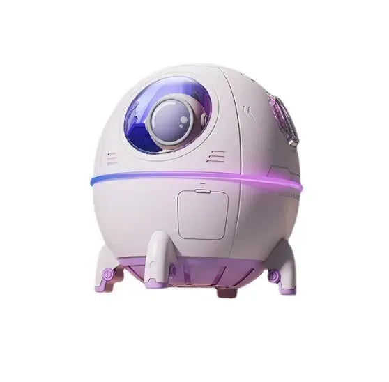 Astronaut-shaped USB desktop humidifier with colourful LED light on a desk.