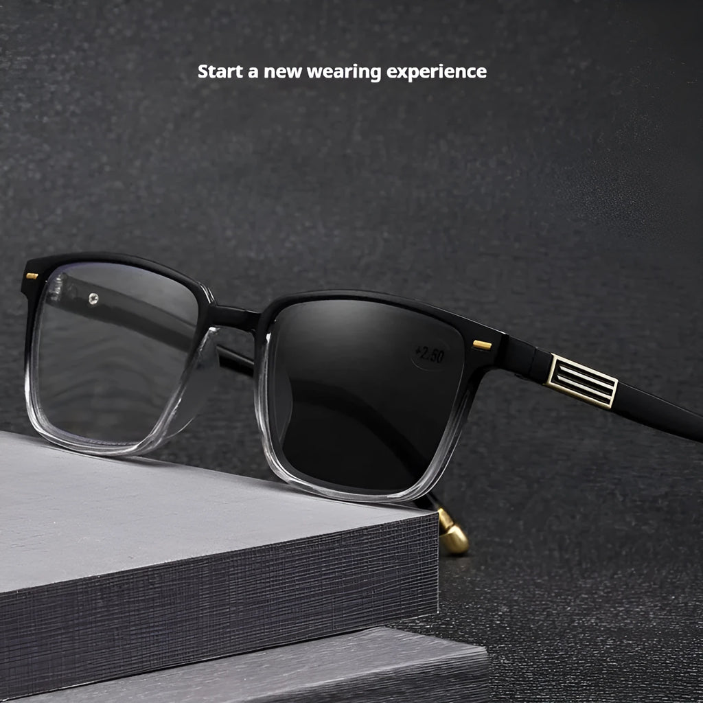 A pair of multifocal reading glasses with colour changing, anti blue light PC lenses in a black and silver frame style.