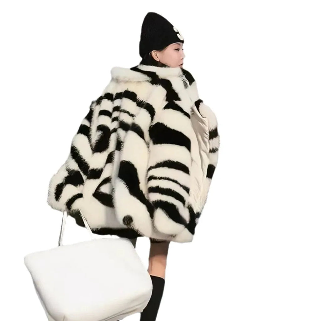 Zebra stripe patterned women's faux fur top with long sleeves and a skimmer collar.