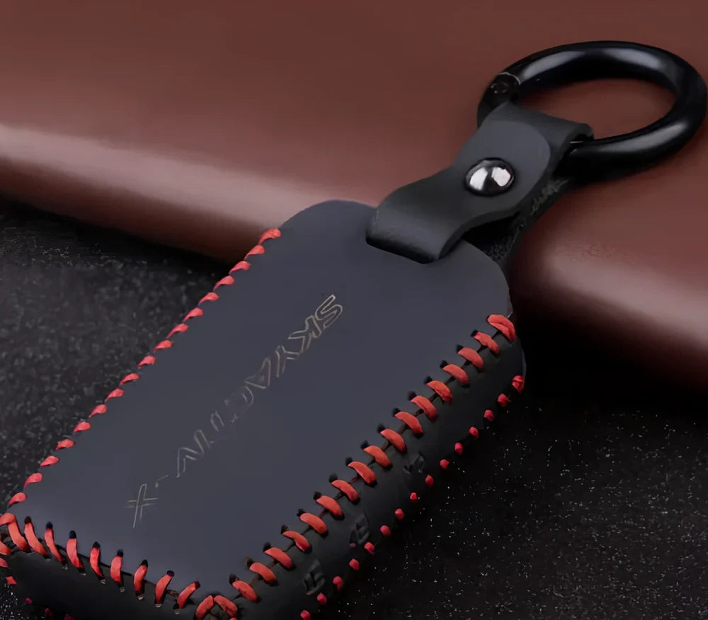 Black Angkesaila leather key case with 3D carbon fibre pattern and red stitching, 10 cm size for fob protection