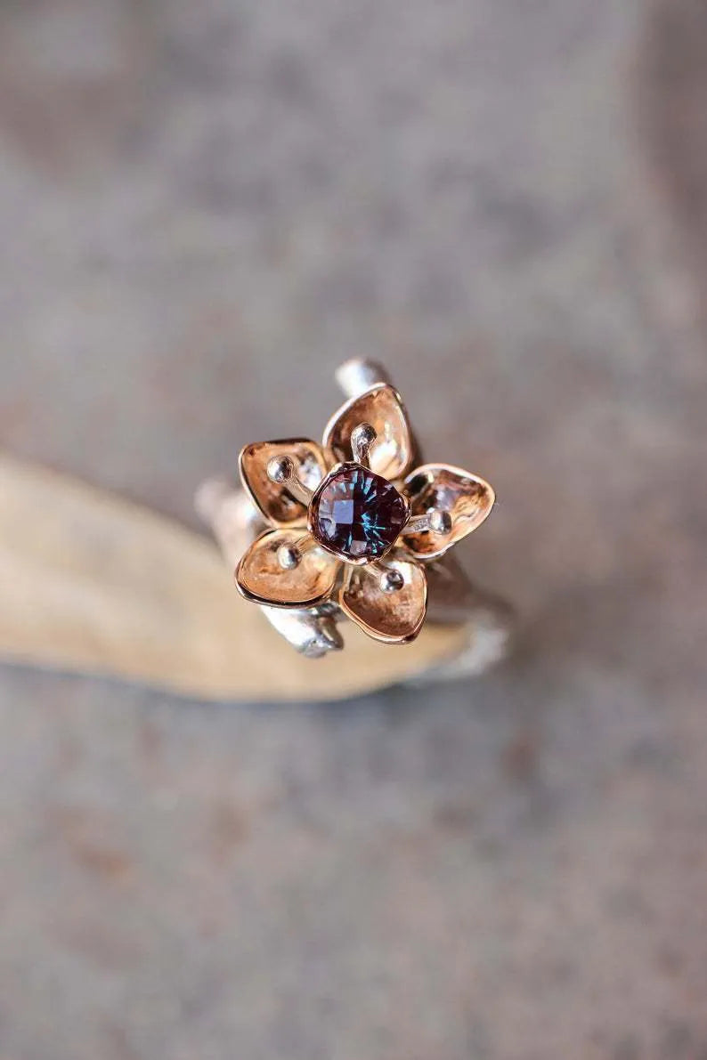 Silver two-tone floral pattern geometric alloy fashion ring for women on a grey background.