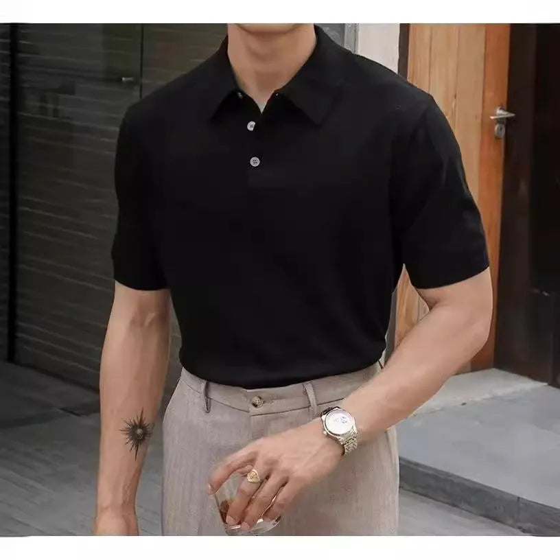Men's black polo shirt with knitted collar and short sleeves laid flat.