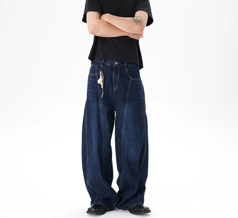 Dark blue washed distressed wide leg machete jeans showing fading and whiskering details