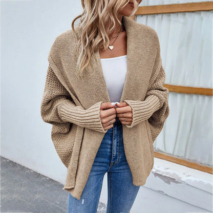 A cozy, oversized knit cardigan with a unique bat-wing sleeve design and large lapel, available in a variety of stylish colors.