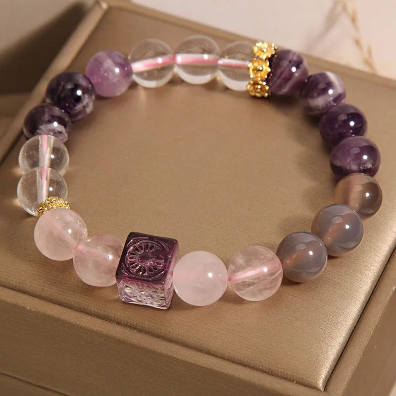 Close-up of a purple women's bracelet with 10mm amethyst crystal beads and rhinestone decoration on an adjustable strap.