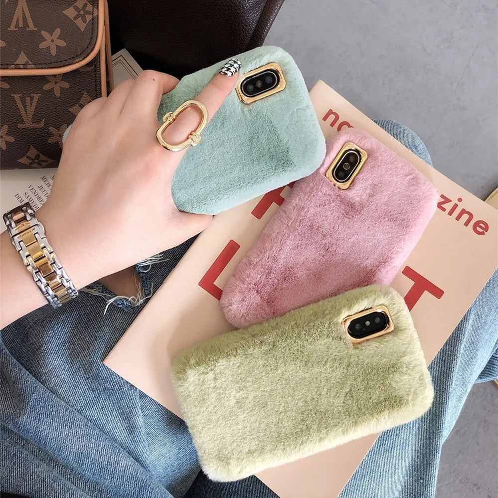 A soft apricot-coloured silicone rabbit plush phone case for an iPhone, showing the raised camera circle and side buttons.